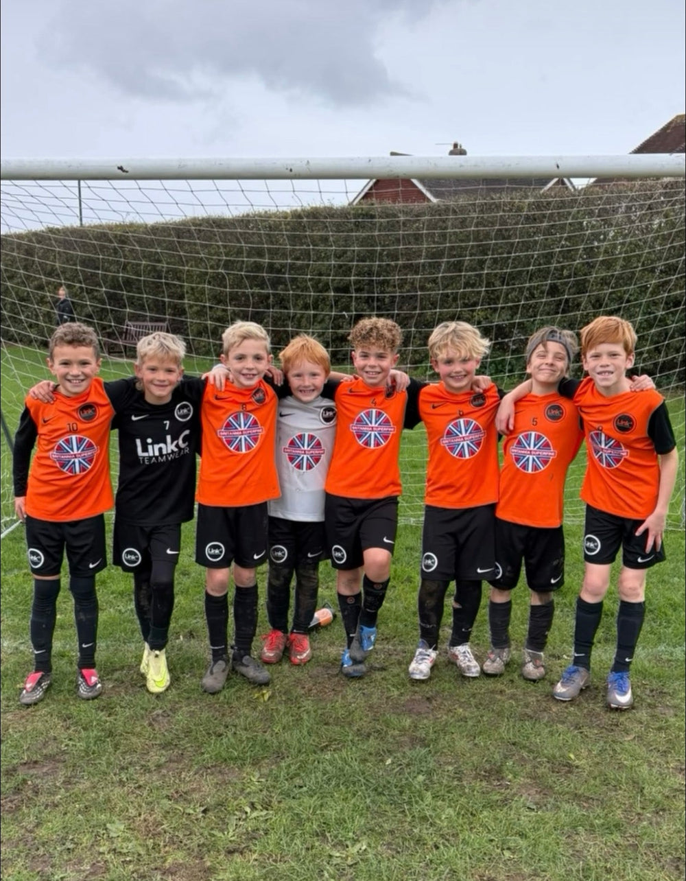 LINK youth players together in orange match shirts